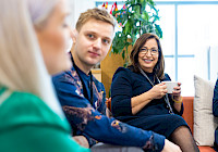 Picture shows people in office room.