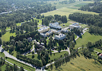 Aerial view of the Old Vaasa Hospital area. The picture was taken in the summer and there are several large buildings in the picture.